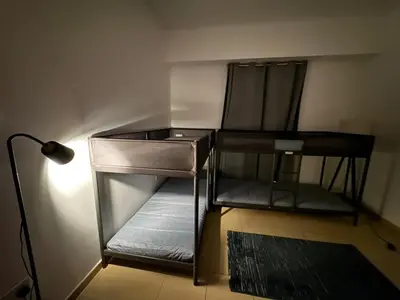 a room with a desk and a chair and a lamp at 50 Shades of stay in Dubai
