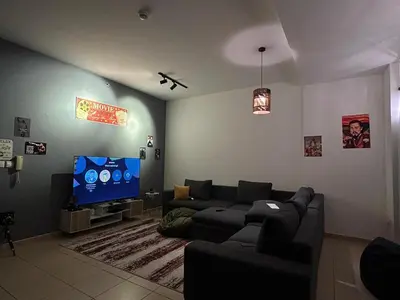 a living room with a couch and a flat screen tv at 50 Shades of stay in Dubai