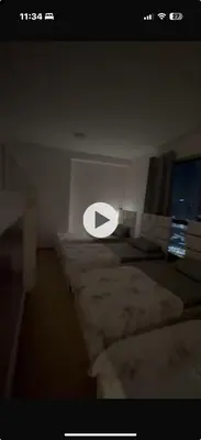 a room with three beds and a white sign on the wall at 50 Shades of stay in Dubai