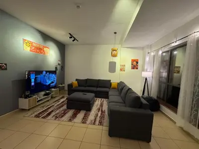a living room with a couch and a flat screen tv at 50 Shades of stay in Dubai