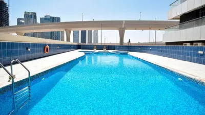a large blue swimming pool on top of a building at Nice Studio On Marina Walk in Dubai