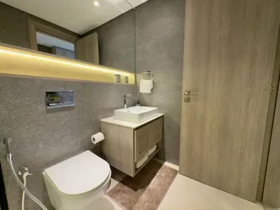a bathroom with a toilet and a sink and a mirror at Elegant and Cozy Studio Apartment - Amenities Access in Dubai