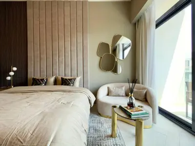 a bedroom with a bed and a chair and a mirror at Elegant and Cozy Studio Apartment - Amenities Access in Dubai