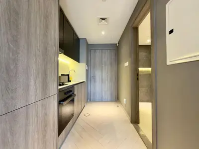 a hallway leading to a kitchen with a door at Elegant and Cozy Studio Apartment - Amenities Access in Dubai