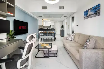 a living room with a couch and a table at Luxury JLT 1BR Lakeview 5 min Metro & Marina in Dubai