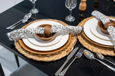 a table with plates and utensils on a table at Luxury JLT 1BR Lakeview 5 min Metro & Marina in Dubai