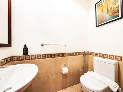 a bathroom with a white toilet and a sink at Palm Jumeirah Beach Paradise at Fairmont Residence in Dubai
