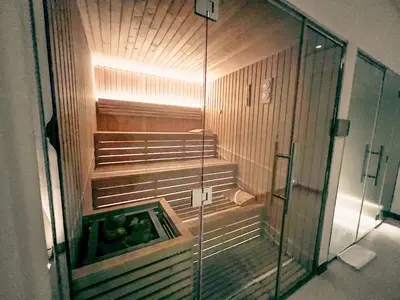 an empty shower in a room with a glass door at Palm Jumeirah Beach Paradise at Fairmont Residence in Dubai