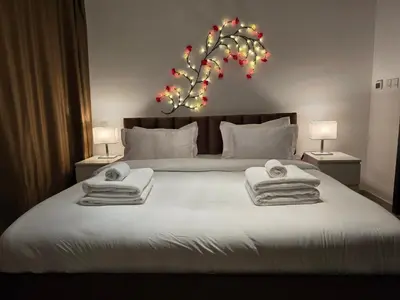 a bedroom with a large bed with towels on it at Dubai Marina Amazing 1BR with Promenade view and Pool view --- Next to JBR beach---Opp JBR tram station in Dubai