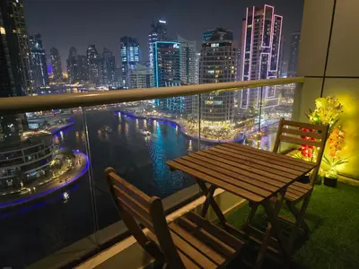 a table and two chairs on a balcony with a city skyline at Dubai Marina Amazing 1BR with Promenade view and Pool view --- Next to JBR beach---Opp JBR tram station in Dubai