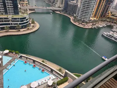 an aerial view of a pool in a river with buildings at Dubai Marina Amazing 1BR with Promenade view and Pool view --- Next to JBR beach---Opp JBR tram station in Dubai