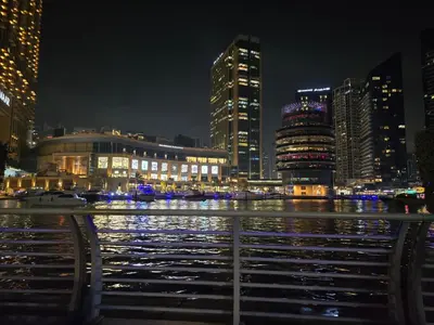 a city lit up at night with a body of water at Dubai Marina Amazing 1BR with Promenade view and Pool view --- Next to JBR beach---Opp JBR tram station in Dubai