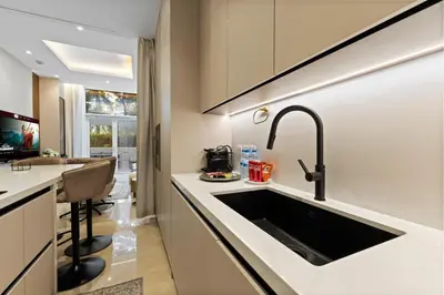 a kitchen with a sink and a counter top at Resort Style 2BR Pool Access Private Beach in Dubai