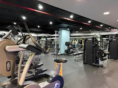 a gym with several treadmills and exercise bikes at Resort Style 2BR Pool Access Private Beach in Dubai