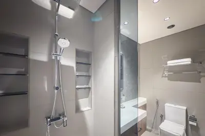 a bathroom with a shower and a toilet at Brand New Luxury One Bedroom in Dubai