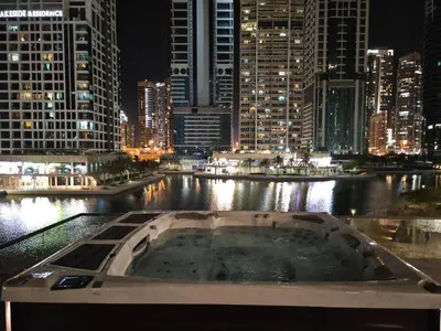 a bath tub in the middle of a city at night at Brand New Luxury One Bedroom in Dubai