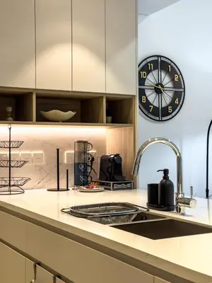 a kitchen with a large clock on the wall at Modern & Luxury 1BR -Pool View - Kensington Waters in Dubai