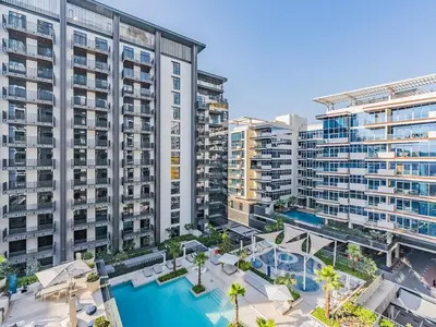 an aerial view of an apartment complex with a swimming pool at Modern & Luxury 1BR -Pool View - Kensington Waters in Dubai