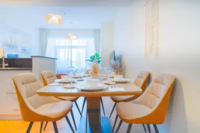a dining room with a table and chairs at 3BR Marina view apartment in JBR Close to Tram & Metro in Dubai