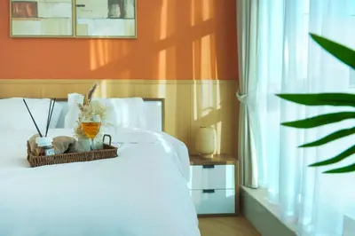 a bedroom with a white bed with a basket on it at 3BR Marina view apartment in JBR Close to Tram & Metro in Dubai