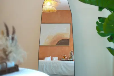 a mirror in a room with a bed and a lamp at 3BR Marina view apartment in JBR Close to Tram & Metro in Dubai