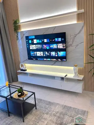 a living room with a large flat screen tv on a wall at 1 BR Apartment in Downtown Dubai in Dubai