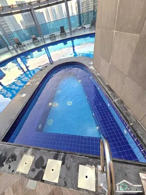 an overhead view of a swimming pool in a building at 1 BR Apartment in Downtown Dubai in Dubai