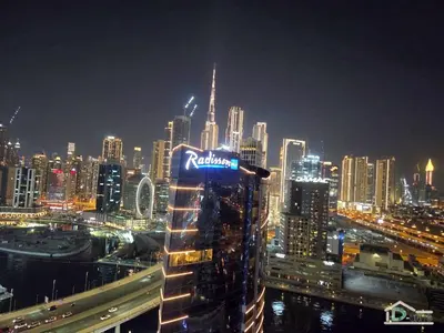 a view of a city skyline at night at 1 BR Apartment in Downtown Dubai in Dubai