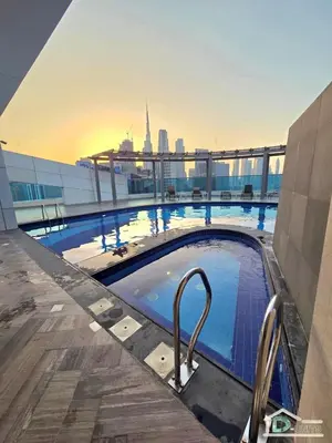 a large swimming pool on top of a building at 1 BR Apartment in Downtown Dubai in Dubai