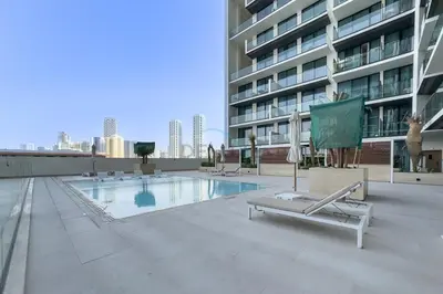 a swimming pool on the roof of a building at Community Views 1BR Next to Mall and Park, Binghatti Amber, Jumeirah Village Circle by Deluxe Holiday Homes in Dubai