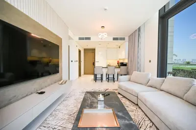 a living room with a couch and a large tv at Crystal Escape 1BR Lagoon Access in Dubai
