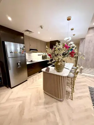 a kitchen with a table with a vase of flowers on it at Cozy, Fully Fitted Smart Home in Dubai
