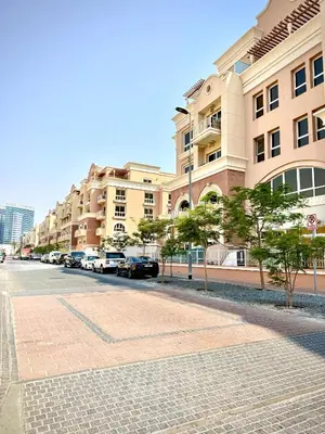 a street with cars parked in front of buildings at Cozy, Fully Fitted Smart Home in Dubai