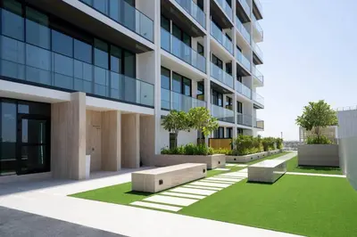 an office building with benches in front of it at Relax In Style 1br Haven In Binghatti Venus! in Dubai