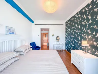a bedroom with a white bed and a blue chair at 1 BHK Palm Jumeirah Sea View Al Sultana Shoreline in Dubai