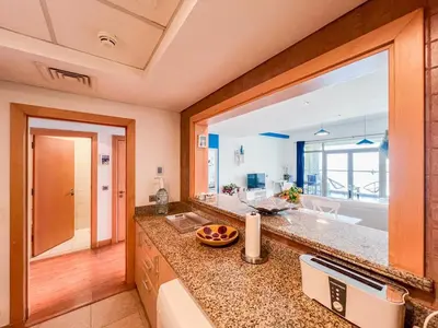 a bathroom with a sink and a large mirror at 1 BHK Palm Jumeirah Sea View Al Sultana Shoreline in Dubai