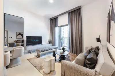 a living room with a couch and a tv at ALiving Elegant 1BR Apartment with Balcony I MAG960 in Dubai