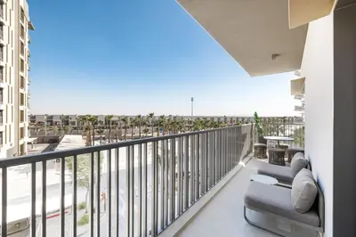 a balcony with a couch and a view of the ocean at ALiving Elegant 1BR Apartment with Balcony I MAG960 in Dubai