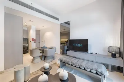 a living room with a couch and a tv in it at ALiving Elegant 1BR Apartment with Balcony I MAG960 in Dubai
