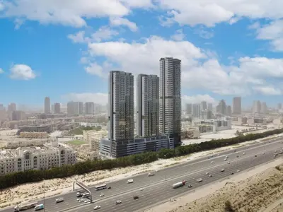 a freeway with tall buildings and a highway with cars at Modern Fully Furnished Apartment in Bloom Tower B JVC - Easy Access to JBR, Circle Mall & Dubai Hills Mall in Dubai