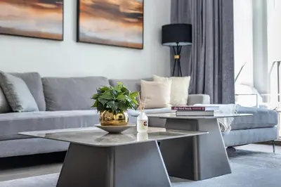 a living room with a couch and a table at GuestReady - Modern design in Dubai Creek Harbour in Dubai