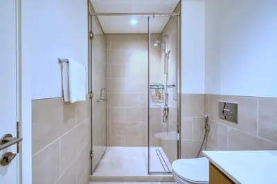 a bathroom with a shower and a toilet at GuestReady - Modern design in Dubai Creek Harbour in Dubai