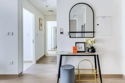 a hallway with a table and two chairs and a mirror at GuestReady - Modern design in Dubai Creek Harbour in Dubai