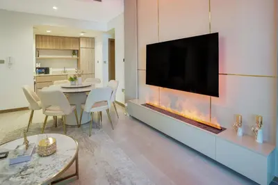a living room with a large entertainment center with a fireplace at 26- Apartment in Business Bay Dubai with Balcony & Pool in Dubai