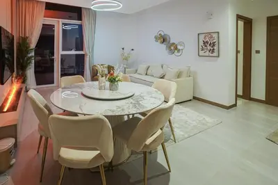 a living room with a table and chairs at 26- Apartment in Business Bay Dubai with Balcony & Pool in Dubai