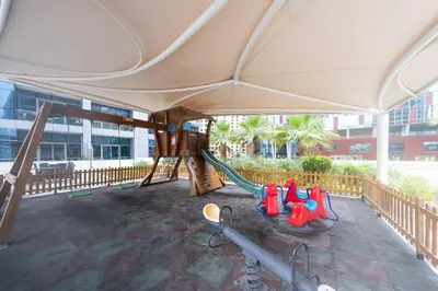 a playground with a hammock and a swing at Stylish place with Breathtaking Marina Views in Dubai