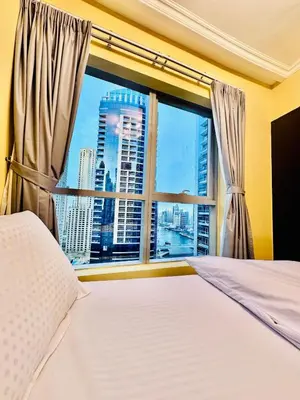 a bedroom with a window with a view of a city at Stylish place with Breathtaking Marina Views in Dubai