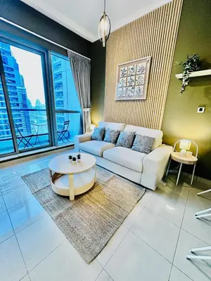 a living room with a white couch and a table at Stylish place with Breathtaking Marina Views in Dubai
