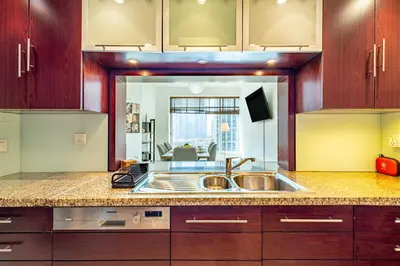 a kitchen with a sink and a large mirror at Vibrant 2BR in Burj Views - Near Dubai Mall & Burj in Dubai