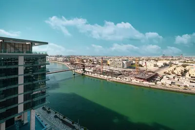 arial view of a city and a river with buildings at Luxury Canal Front with Burj Khalifa Skyline View in Dubai